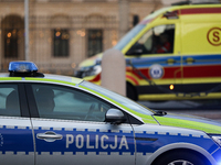 A police car with lights and an ambulance are on the street in Warsaw, Poland, on December 12, 2024. (