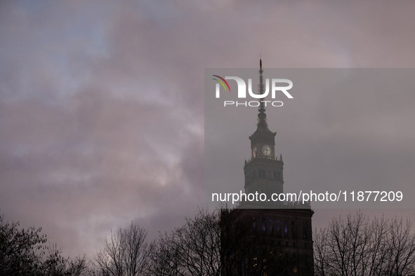 The Palace of Culture and Science is visible among tree branches on the street in Warsaw, Poland, on December 12, 2024. 