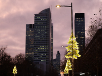 Christmas decorations in the form of glowing Christmas trees hang from street lamps in Warsaw, Poland, on December 12, 2024. (