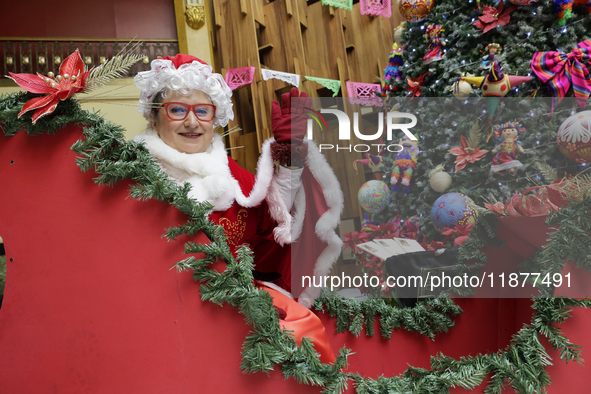 Mrs. Claus is aboard a sleigh inside the Mexican Postal Service at the Postal Palace in the Zocalo of Mexico City, Mexico, on December 17, 2...