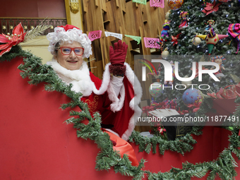 Mrs. Claus is aboard a sleigh inside the Mexican Postal Service at the Postal Palace in the Zocalo of Mexico City, Mexico, on December 17, 2...