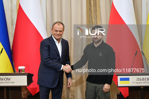 In Lviv, Ukraine, on December 17, 2024, President of Ukraine Volodymyr Zelenskyy and Polish Prime Minister Donald Tusk shake hands at the en...