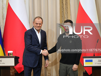 In Lviv, Ukraine, on December 17, 2024, President of Ukraine Volodymyr Zelenskyy and Polish Prime Minister Donald Tusk shake hands at the en...