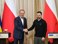 In Lviv, Ukraine, on December 17, 2024, President of Ukraine Volodymyr Zelenskyy and Polish Prime Minister Donald Tusk shake hands at the en...