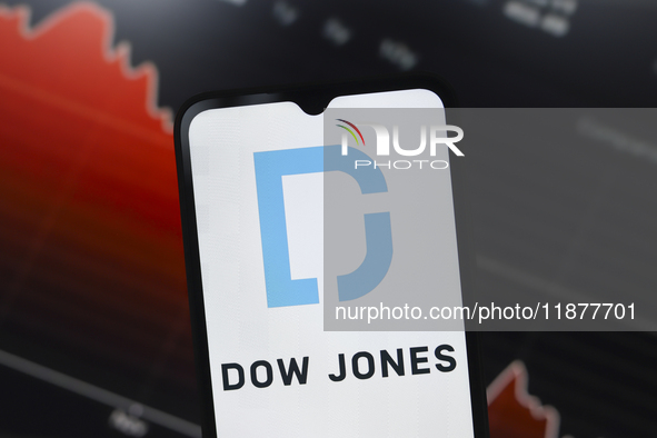 The Dow Jones Industrial Average logo appears on a smartphone screen in this illustration photo in Reno, United States, on December 17, 2024...