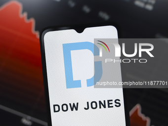 The Dow Jones Industrial Average logo appears on a smartphone screen in this illustration photo in Reno, United States, on December 17, 2024...