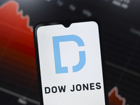 The Dow Jones Industrial Average logo appears on a smartphone screen in this illustration photo in Reno, United States, on December 17, 2024...