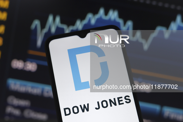 The Dow Jones Industrial Average logo appears on a smartphone screen in this illustration photo in Reno, United States, on December 17, 2024...