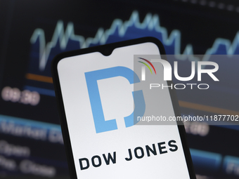 The Dow Jones Industrial Average logo appears on a smartphone screen in this illustration photo in Reno, United States, on December 17, 2024...