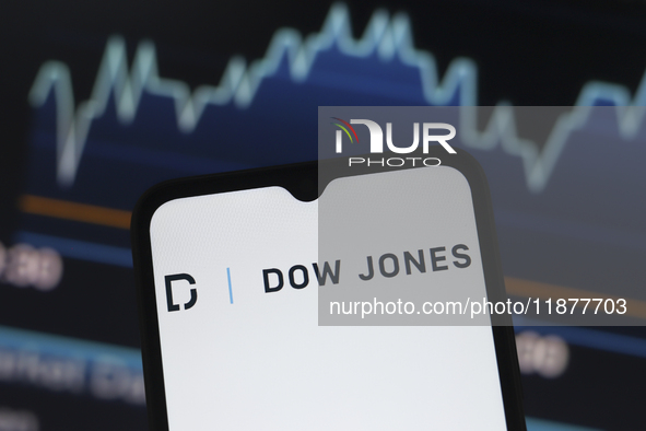 The Dow Jones Industrial Average logo appears on a smartphone screen in this illustration photo in Reno, United States, on December 17, 2024...