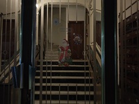 The entrance of an apartment building in Athens, Greece, on December 16, 2024, is decorated with figures of Santa Claus. (