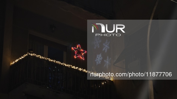 Christmas lights and snowflake-shaped lighting are on a balcony in Athens, Greece, on December 16, 2024. 