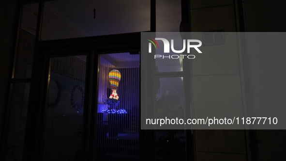 The entrance of an apartment building in Athens, Greece, on December 16, 2024, is decorated with Christmas lights and the figure of Santa Cl...