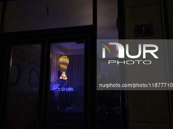 The entrance of an apartment building in Athens, Greece, on December 16, 2024, is decorated with Christmas lights and the figure of Santa Cl...