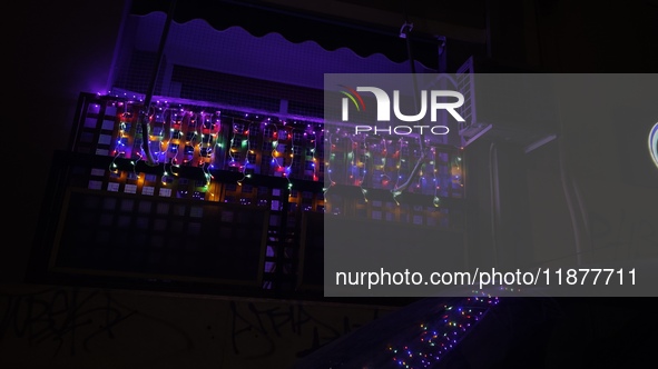 A garland with Christmas lights is on a balcony in Athens, Greece, on December 16, 2024. 