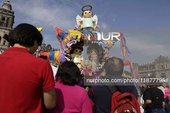 Dozens of people attend a Christmas Village in the Zocalo of Mexico City, Mexico, on December 17, 2024. 