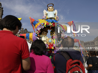 Dozens of people attend a Christmas Village in the Zocalo of Mexico City, Mexico, on December 17, 2024. (