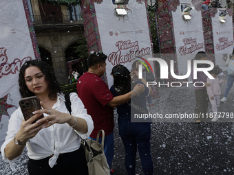 Dozens of people attend a Christmas Village in the Zocalo of Mexico City, Mexico, on December 17, 2024. (