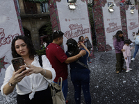 Dozens of people attend a Christmas Village in the Zocalo of Mexico City, Mexico, on December 17, 2024. (