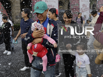 Dozens of people attend a Christmas Village in the Zocalo of Mexico City, Mexico, on December 17, 2024. (