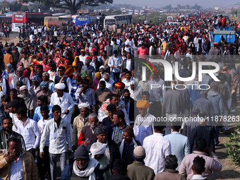 People arrive to attend Prime Minister Narendra Modi's public meeting for the 'Ek Varsh-Parinaam Utkarsh' event, marking the completion of o...