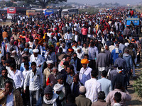 People arrive to attend Prime Minister Narendra Modi's public meeting for the 'Ek Varsh-Parinaam Utkarsh' event, marking the completion of o...