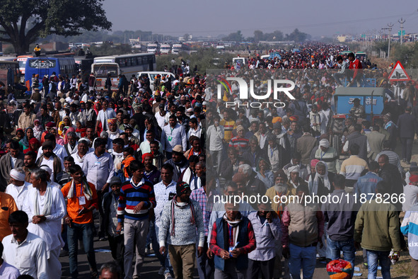 People arrive to attend Prime Minister Narendra Modi's public meeting for the 'Ek Varsh-Parinaam Utkarsh' event, marking the completion of o...