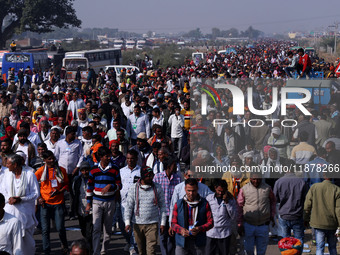 People arrive to attend Prime Minister Narendra Modi's public meeting for the 'Ek Varsh-Parinaam Utkarsh' event, marking the completion of o...