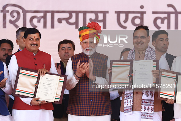 Prime Minister Narendra Modi with Rajasthan Chief Minister Bhajan Lal Sharma and Madhya Pradesh Chief Minister Mohan Yadav as they show the...