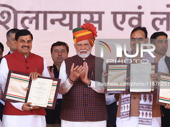 Prime Minister Narendra Modi with Rajasthan Chief Minister Bhajan Lal Sharma and Madhya Pradesh Chief Minister Mohan Yadav as they show the...