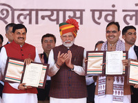 Prime Minister Narendra Modi with Rajasthan Chief Minister Bhajan Lal Sharma and Madhya Pradesh Chief Minister Mohan Yadav as they show the...