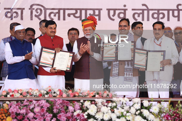 Prime Minister Narendra Modi with Rajasthan Chief Minister Bhajan Lal Sharma and Madhya Pradesh Chief Minister Mohan Yadav as they show the...