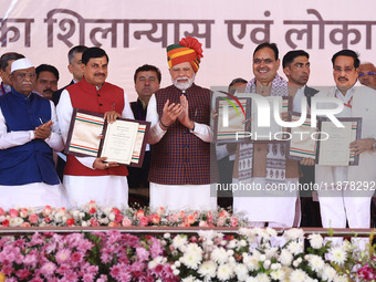 Prime Minister Narendra Modi with Rajasthan Chief Minister Bhajan Lal Sharma and Madhya Pradesh Chief Minister Mohan Yadav as they show the...