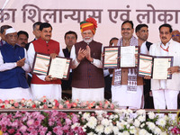 Prime Minister Narendra Modi with Rajasthan Chief Minister Bhajan Lal Sharma and Madhya Pradesh Chief Minister Mohan Yadav as they show the...