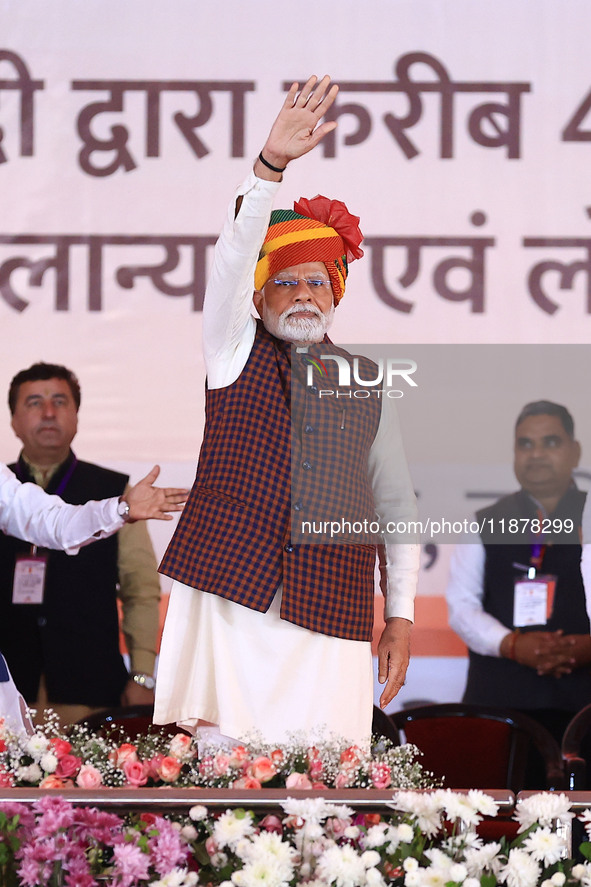 Prime Minister Narendra Modi greets the gathering during the 'Ek Varsh-Parinaam Utkarsh' event, marking the completion of one year of the Ra...