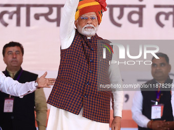 Prime Minister Narendra Modi greets the gathering during the 'Ek Varsh-Parinaam Utkarsh' event, marking the completion of one year of the Ra...