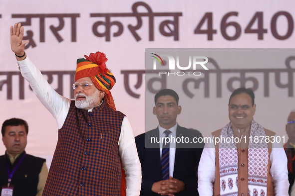 Prime Minister Narendra Modi greets the gathering during the 'Ek Varsh-Parinaam Utkarsh' event, marking the completion of one year of the Ra...