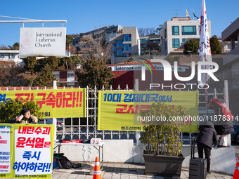 Members of the National Transformation Promotion Committee of Hell Joseon display a flag calling for the president's resignation on the side...