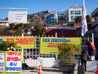 Members of the National Transformation Promotion Committee of Hell Joseon display a flag calling for the president's resignation on the side...