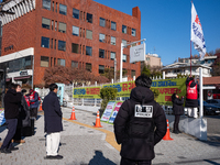 Members of the National Transformation Promotion Committee of Hell Joseon display a flag calling for the president's resignation on the side...