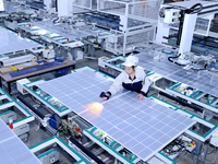 A worker produces solar photovoltaic products at a digital workshop in Suqian, Jiangsu province, China, on December 17, 2024. (