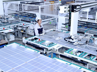 A worker produces solar photovoltaic products at a digital workshop in Suqian, Jiangsu province, China, on December 17, 2024. (