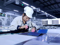 A worker produces solar photovoltaic products at a digital workshop in Suqian, Jiangsu province, China, on December 17, 2024. (