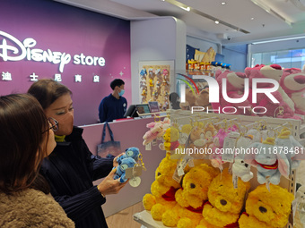 Customers shop at a newly opened Disney store on Nanjing Road Pedestrian Street in Shanghai, China, on December 18, 2024. (