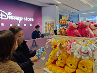 Customers shop at a newly opened Disney store on Nanjing Road Pedestrian Street in Shanghai, China, on December 18, 2024. (