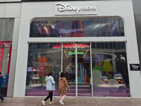 Customers shop at a newly opened Disney store on Nanjing Road Pedestrian Street in Shanghai, China, on December 18, 2024. (