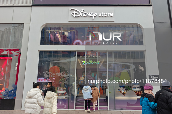 Customers walk past a newly opened Disney store on Nanjing Road Pedestrian Street in Shanghai, China, on December 18, 2024. 