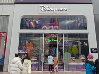 Customers walk past a newly opened Disney store on Nanjing Road Pedestrian Street in Shanghai, China, on December 18, 2024. (