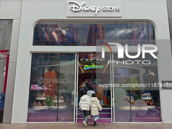 Customers walk past a newly opened Disney store on Nanjing Road Pedestrian Street in Shanghai, China, on December 18, 2024. (