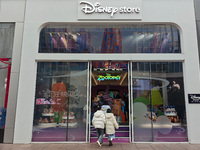 Customers walk past a newly opened Disney store on Nanjing Road Pedestrian Street in Shanghai, China, on December 18, 2024. (